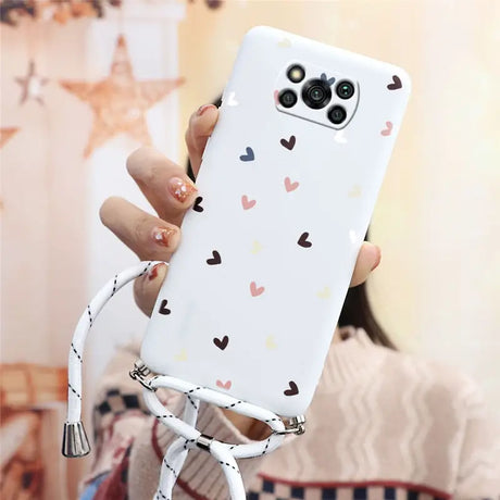 a woman holding a phone case with hearts on it