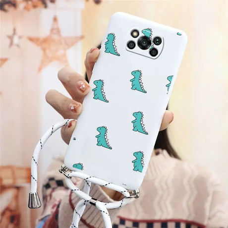 a woman holding a phone case with a green dinosaur pattern