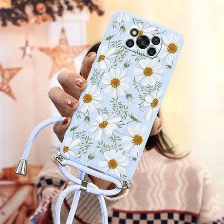 a woman holding a phone case with flowers on it