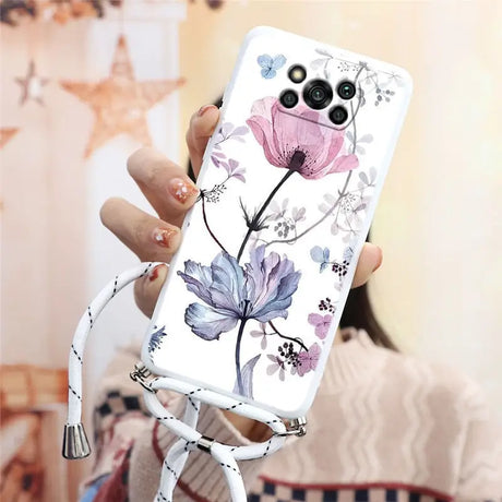 a woman holding a phone case with flowers on it