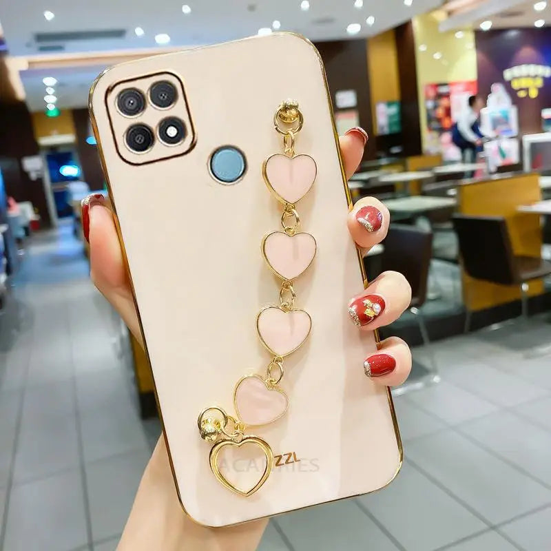a woman holding a phone case with a heart shaped ring
