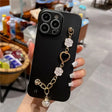 a woman holding a phone case with a chain and flower