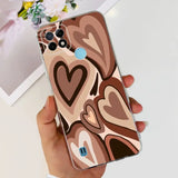a person holding a phone case with a heart design