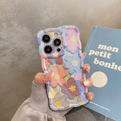 a person holding a phone case with a book