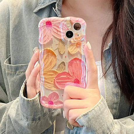 a woman holding a phone case with flowers on it