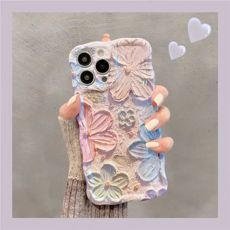 a woman holding a phone case with a flower design