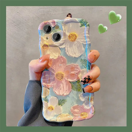 a woman holding a phone case with flowers on it