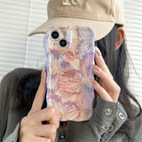 a woman holding a phone case with a pink marble pattern