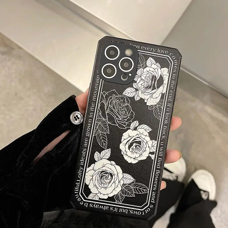 a woman holding a phone case with roses on it