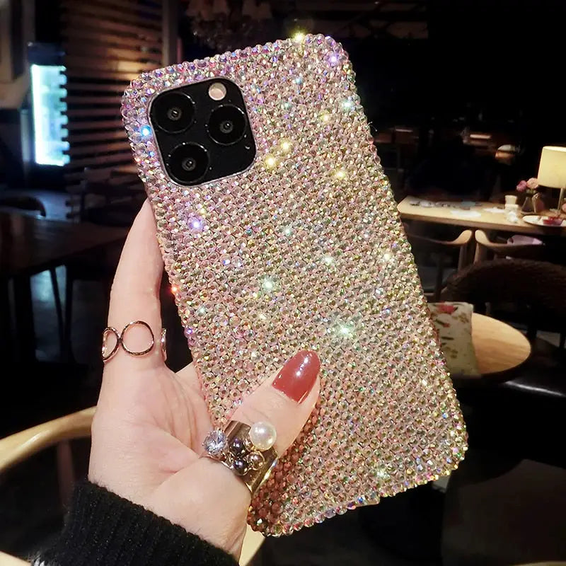 a woman holding up a phone case with a diamond design