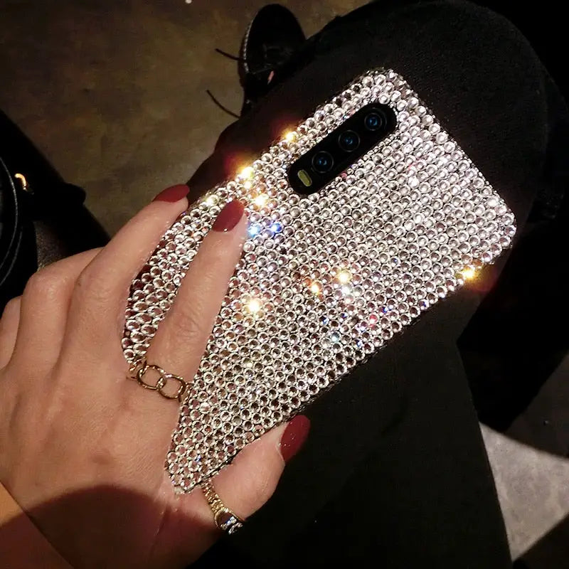 a woman holding a phone case with a diamond design