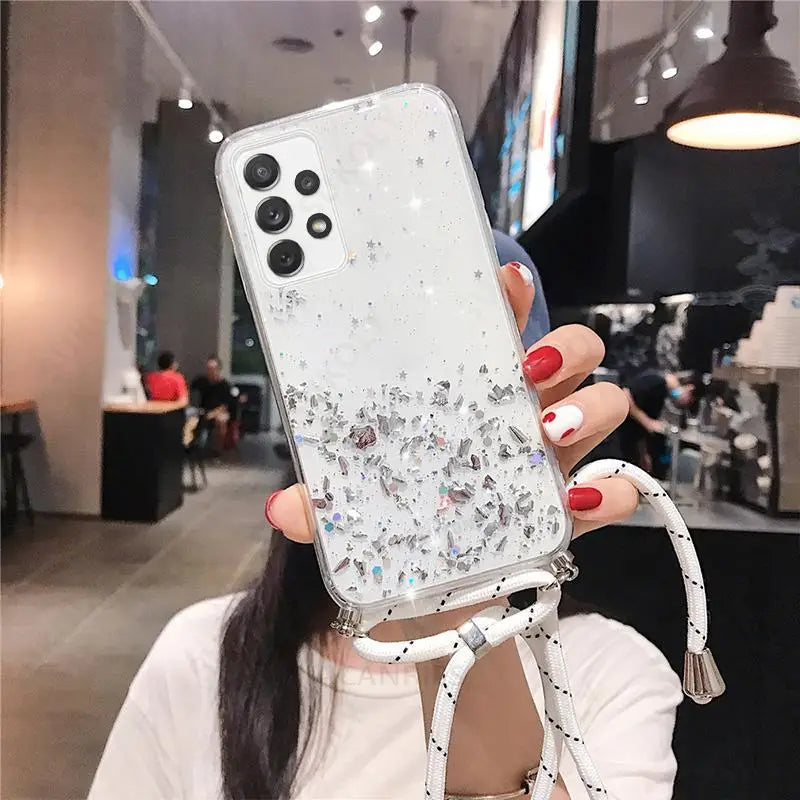 a woman holding up a phone case with a white and silver glitter design