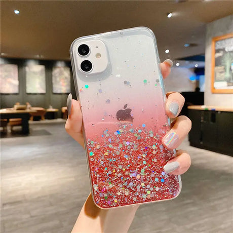 a woman holding up a phone case with glitter