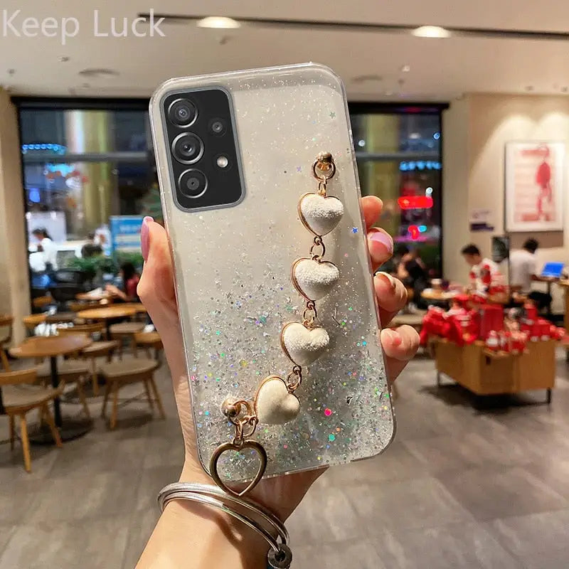 a woman holding up a phone case with a white and silver glitter phone case