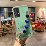 a woman holding up a phone case with blue and green marble