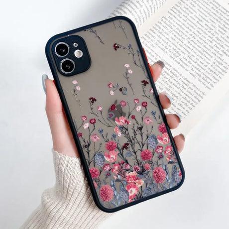 a woman holding a phone case with flowers on it