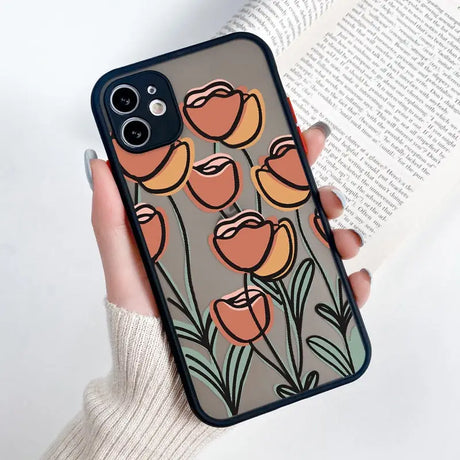 a woman holding a phone case with flowers on it