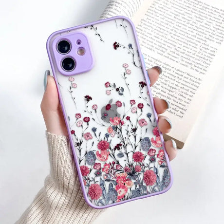 a woman holding a phone case with flowers on it