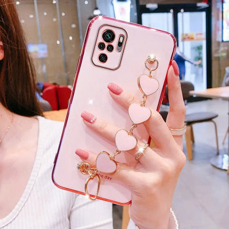 a woman holding a phone case with a ring on it