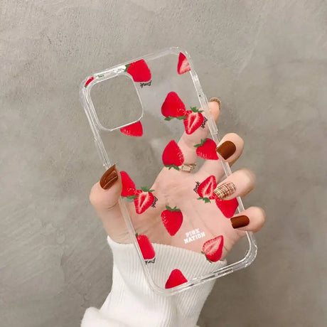 a woman holding a phone case with strawberries on it