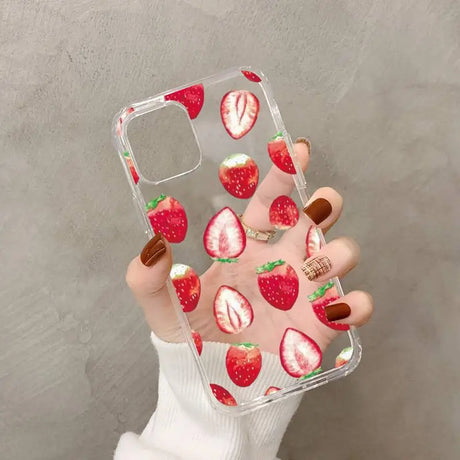 a woman holding a phone case with strawberries on it