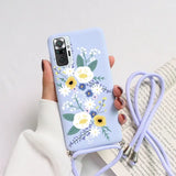 a woman holding a phone case with flowers on it