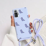 a woman holding a phone case with a blue unicorn pattern