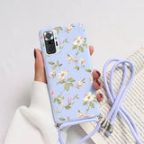 a woman holding a phone case with a flower pattern