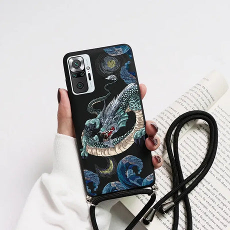 a woman holding a phone case with a dragon on it