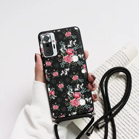 a woman holding a phone case with flowers on it