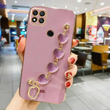 a woman holding a phone case with purple heart charms