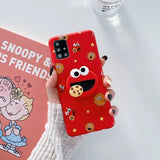 a woman holding a red phone case with a cartoon character on it