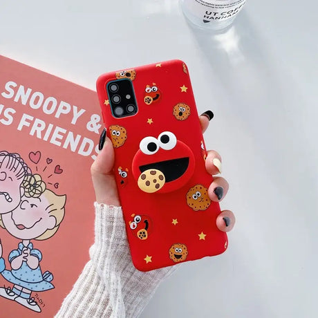 a woman holding a red phone case with a cartoon character on it