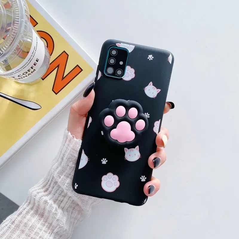 a woman holding a phone case with a cat design