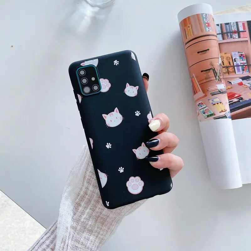 a woman holding a phone case with a cat pattern