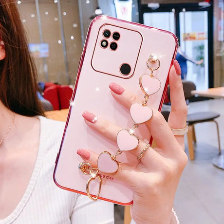 a woman holding a phone case with a ring on it