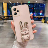 a woman holding a phone case with a rabbit on it