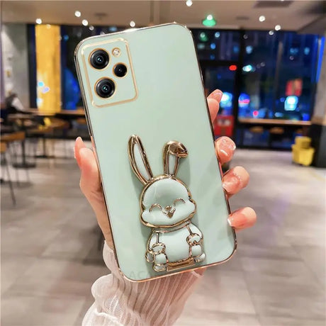 a woman holding a phone case with a rabbit on it