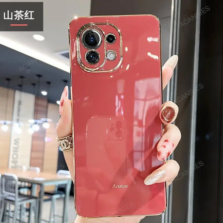 a woman holding a red phone case