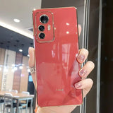 a woman holding up a red phone case