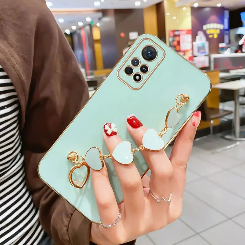 a woman holding a phone case with two rings on it
