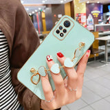 a woman holding a phone case with two rings on it
