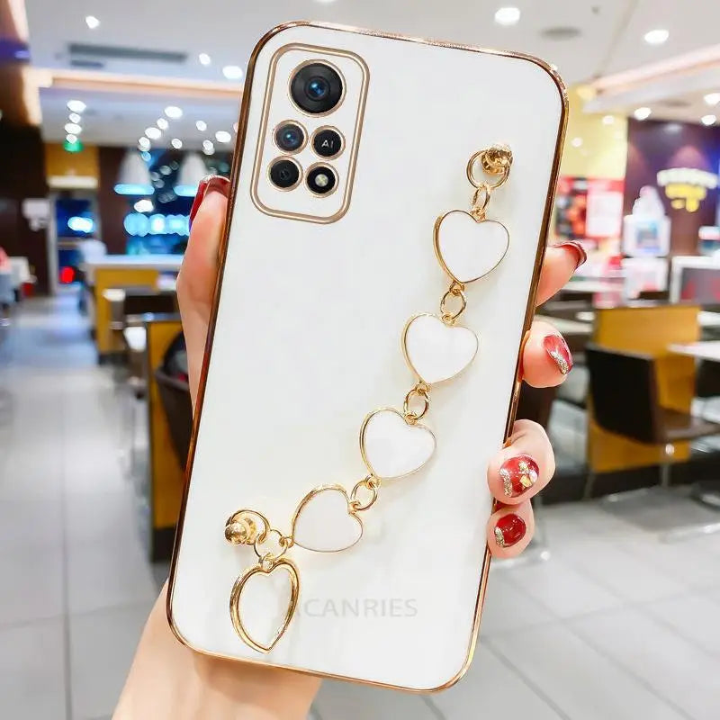 a woman holding a phone case with a gold ring