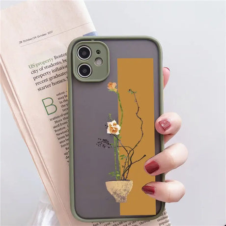 a woman holding a phone case with a flower on it