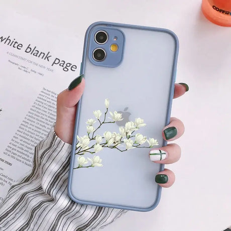 a woman holding a phone case with flowers on it