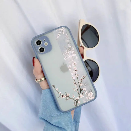 a woman holding a phone case with a flower design