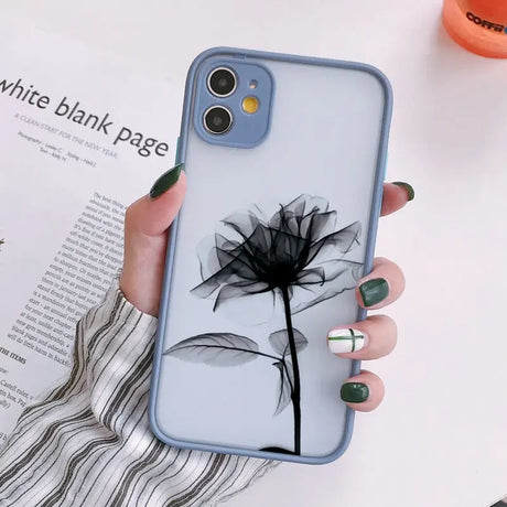 a woman holding a phone case with a flower on it