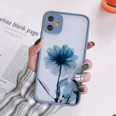 a woman holding a phone case with a flower on it