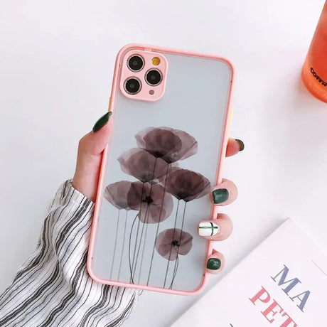 a woman holding a phone case with a flower design