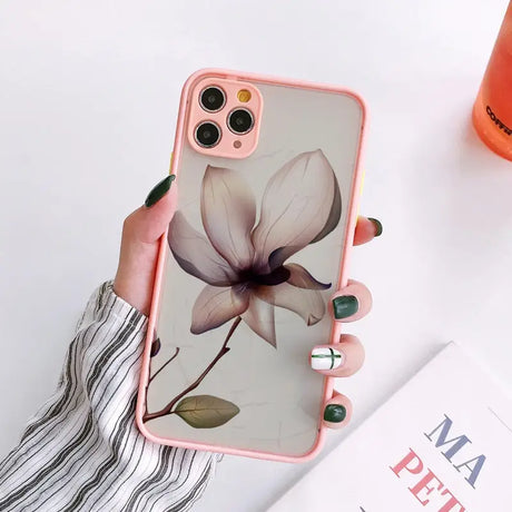 a woman holding a phone case with a flower on it